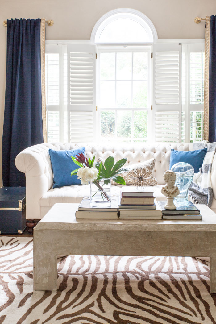 Front Room, Family Room, Modern Chic, Zebra Rug, Tufted Sofa, brass, concrete table