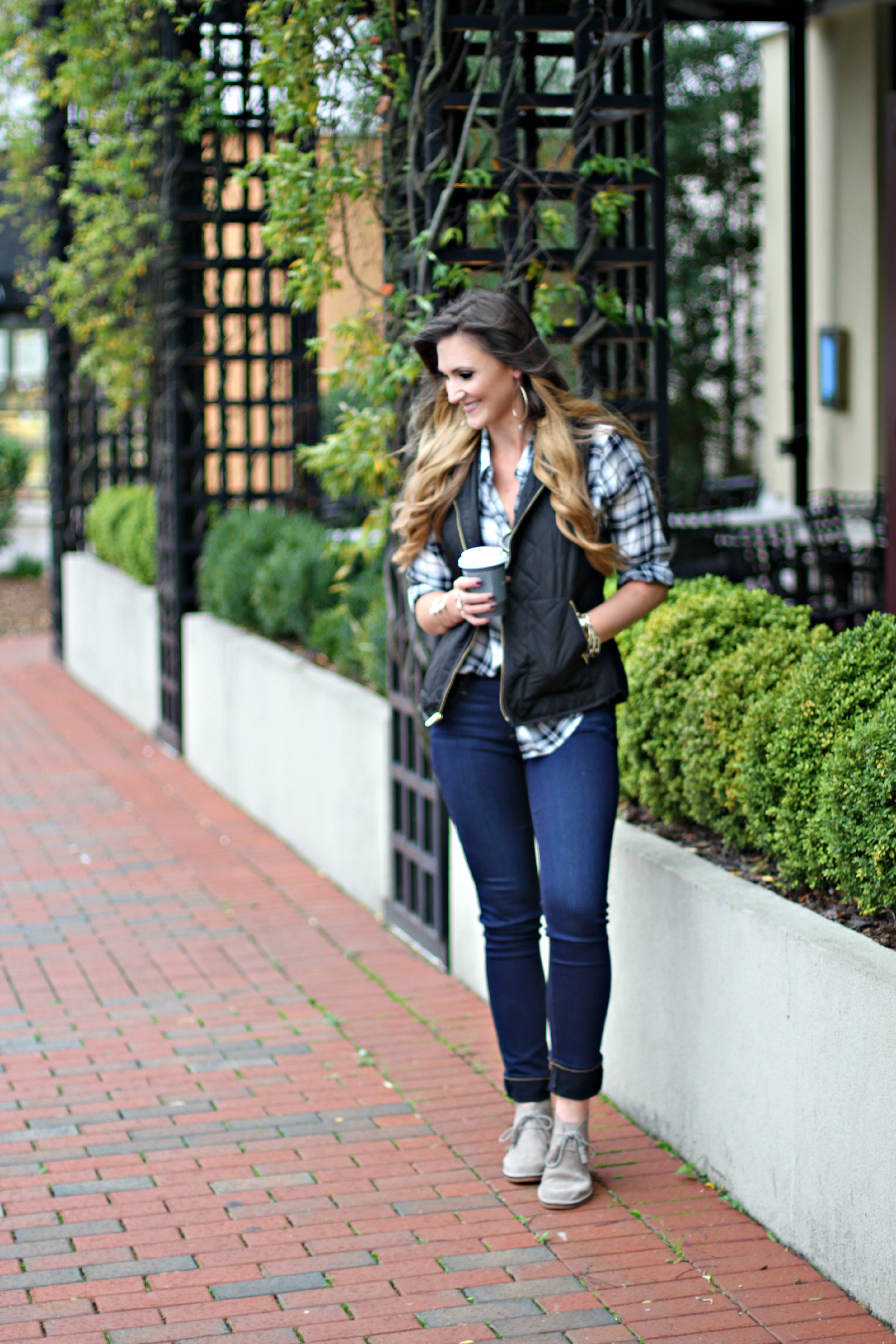 plaid shirt, puffer vest, chukka boots, coffee, skinny jeans