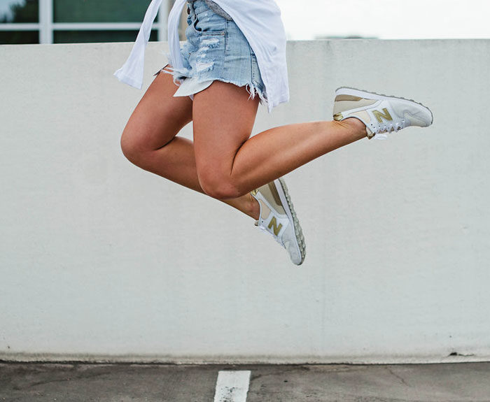White and gold New Balance sneakers for women