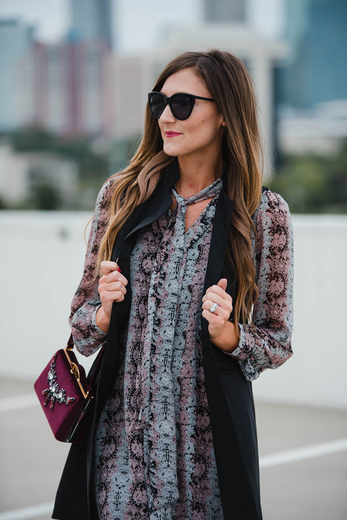 Blogger Mallory Fitzsimmons of Style Your Senses wears a Cece by Cynthia Steffe paisley dress with a black trench vest and Vince Camuto mid calf booties