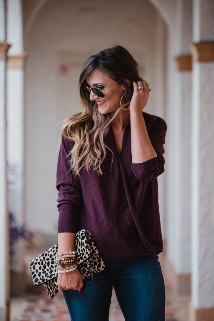 Blogger Mallory Fitzsimmons of Style Your Senses is wearing a merlot wrap front sweater and distressed skinny jeans for a Fall casual outfit that's chic and comfortable